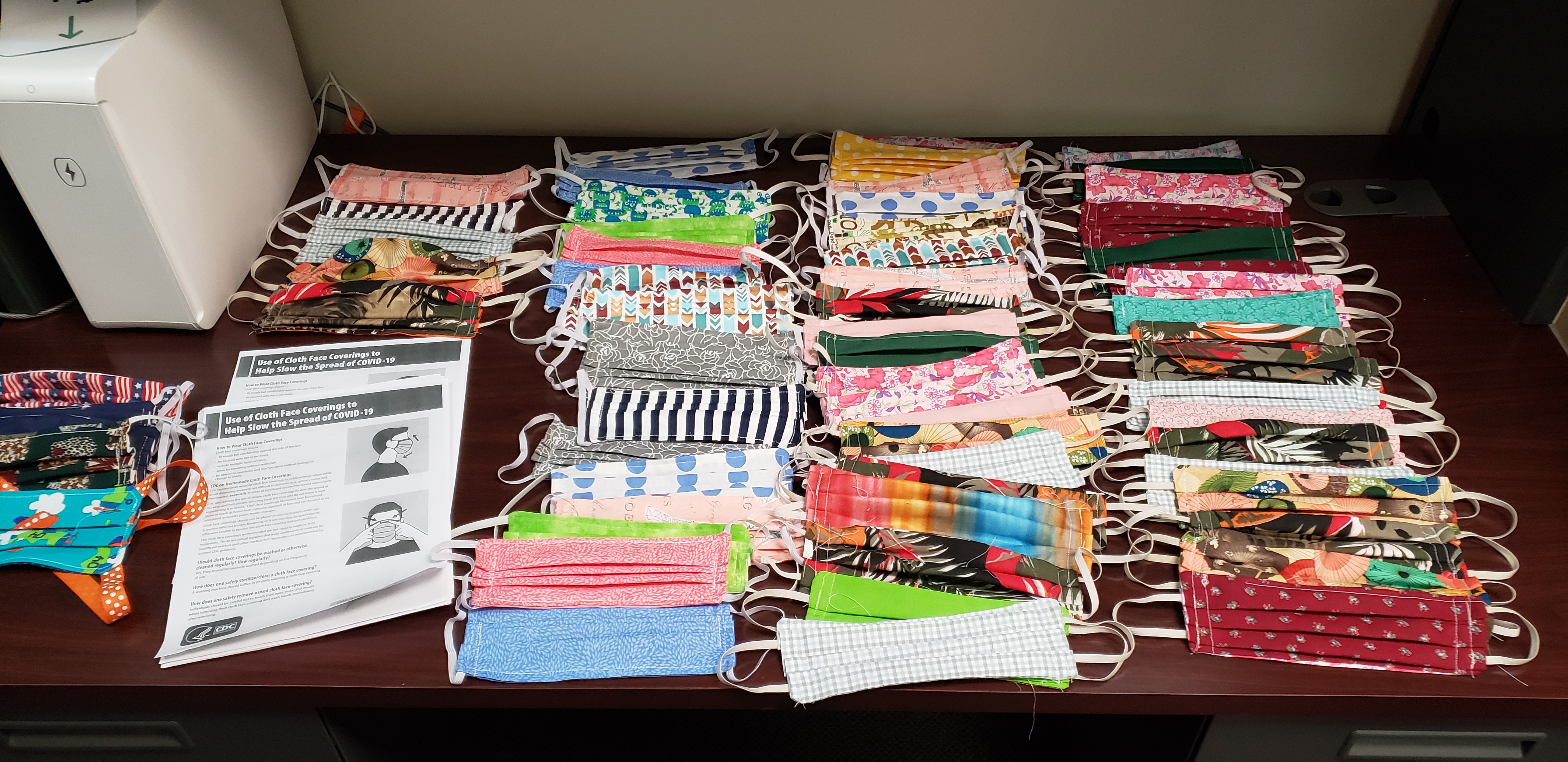 many different colored face masks on a table